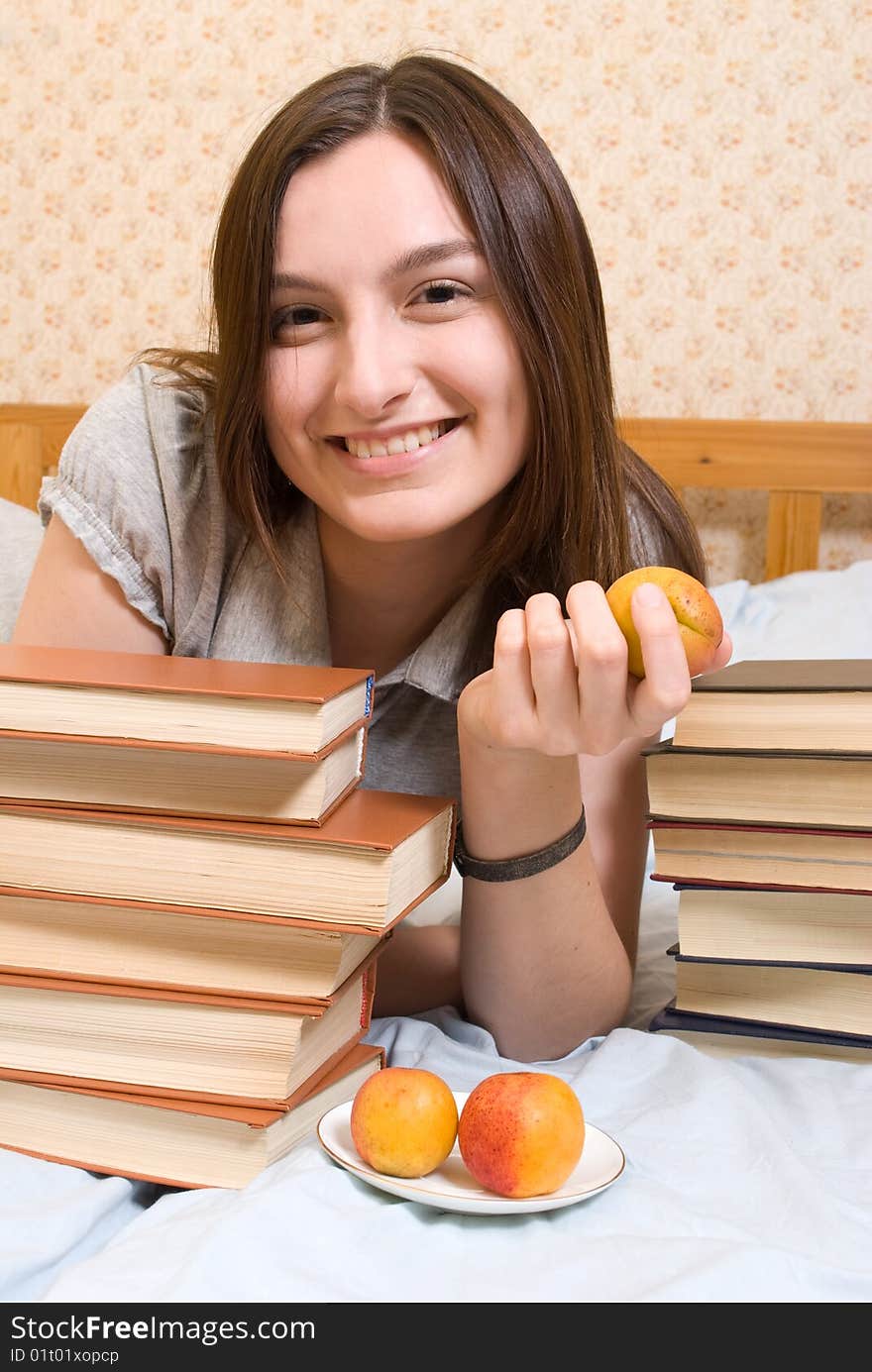 young woman with  peach and books