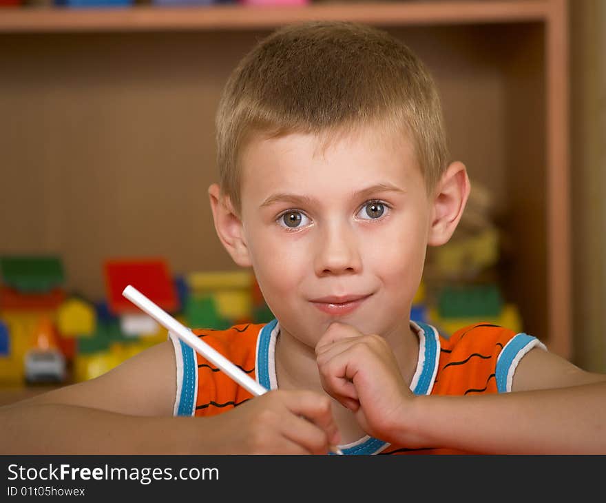 The boy of 7 years is engaged in a children's room