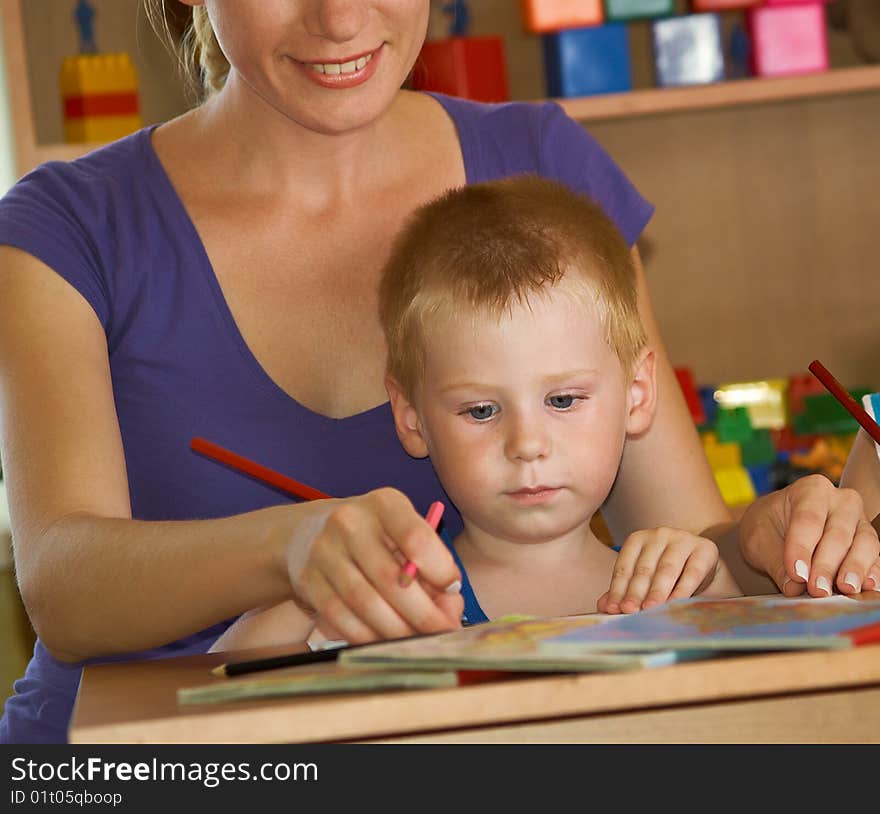 The mum with son is engaged in a children's room. The mum with son is engaged in a children's room