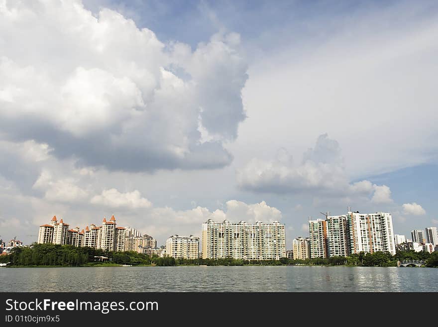 Chinese peaceful community with some modern buildings beside the lake in a beautiful day,Foshan,Canton,China. Chinese peaceful community with some modern buildings beside the lake in a beautiful day,Foshan,Canton,China