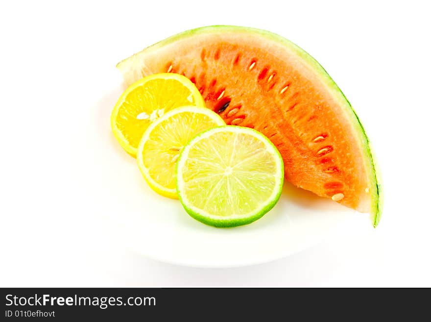 Slices of lemon, lime and orange with a slice of juicy watermelon on a white background. Slices of lemon, lime and orange with a slice of juicy watermelon on a white background