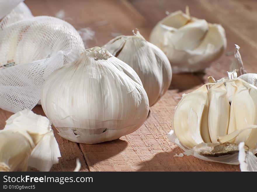 Fresh garlic cloves on wooden table