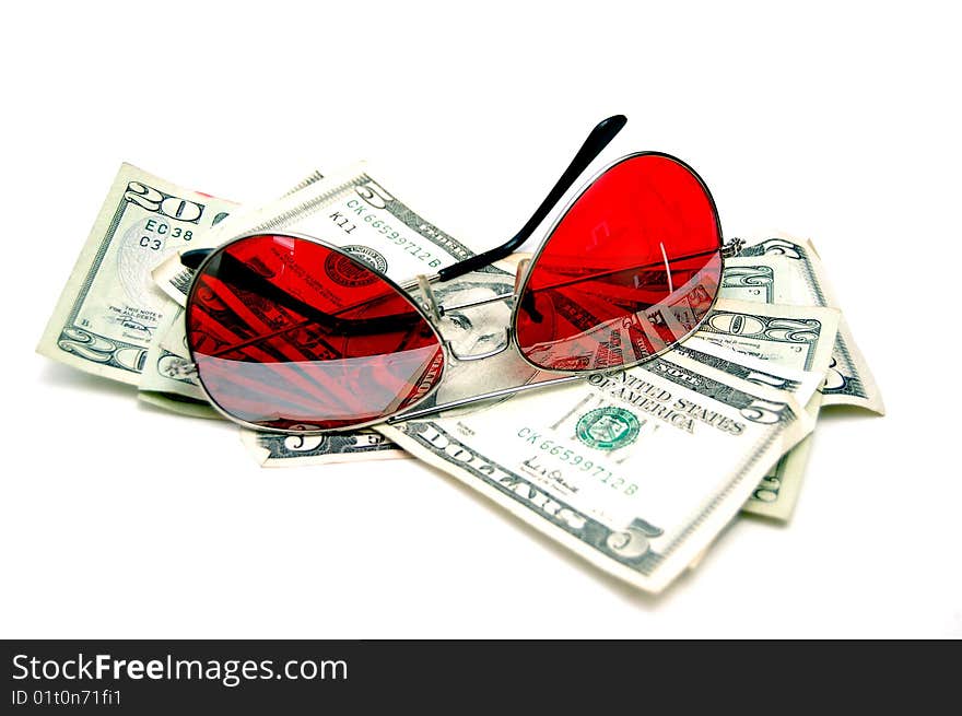 Red sunglasses resting on cash