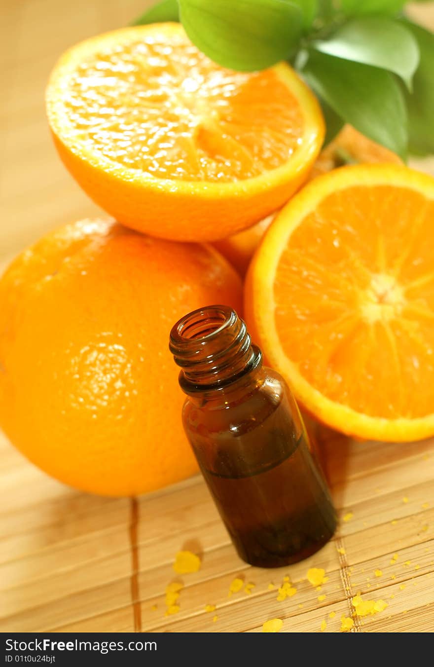 Bottle Of Essence Oil And Fresh Oranges