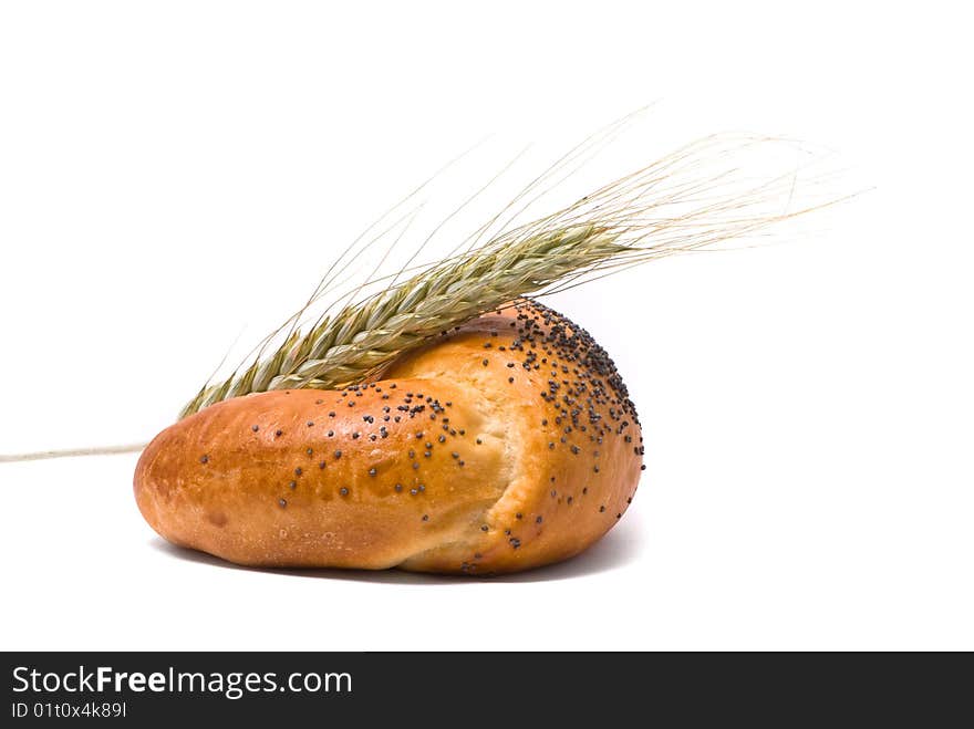 Single fresh bun and ear of wheat