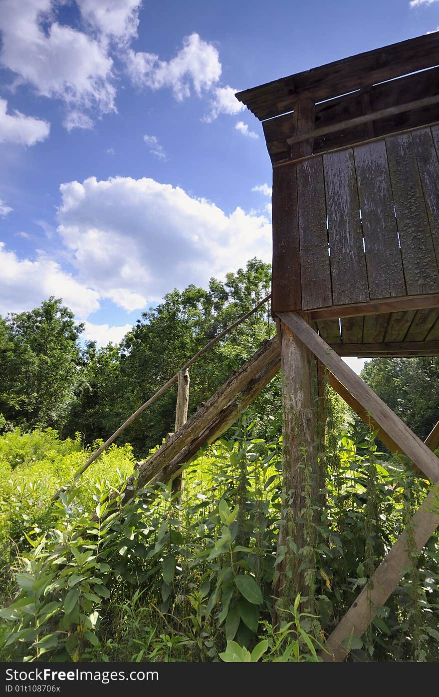 Wooden hunting watchtower in the oak forest