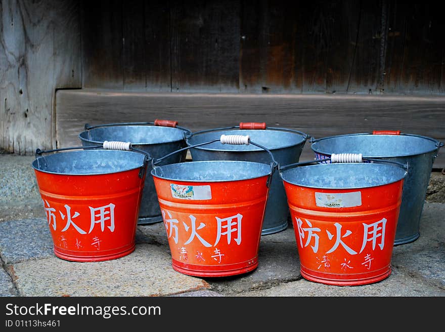 Red buckets near japanese temple. Red buckets near japanese temple