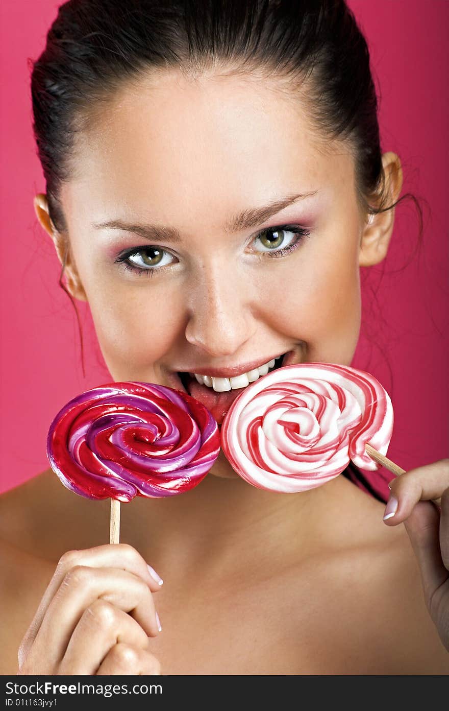 Smiling woman with a lollipop