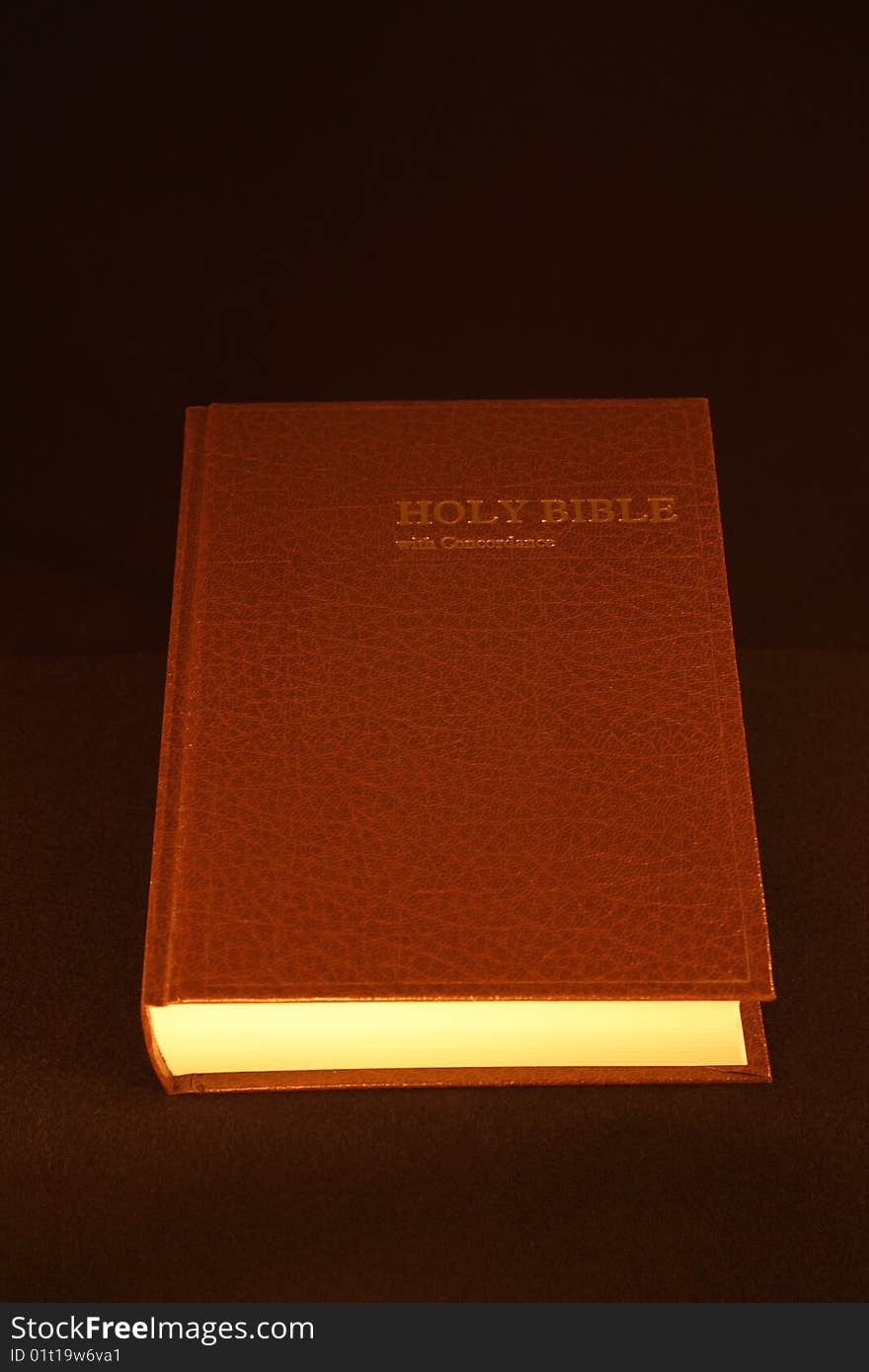 The Holy Bible under candle light.