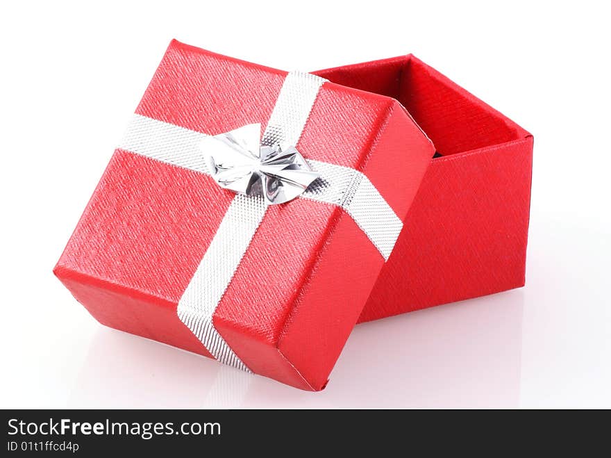 Red gift box with silver ribbon isolated on white. Red gift box with silver ribbon isolated on white.