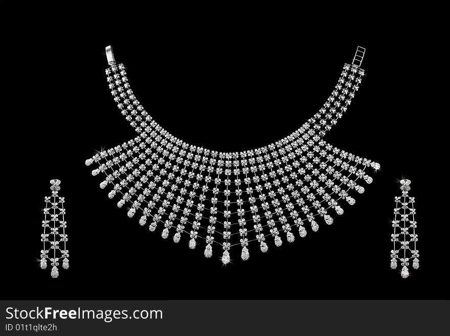 Diamond necklace on dark black background with ear rings