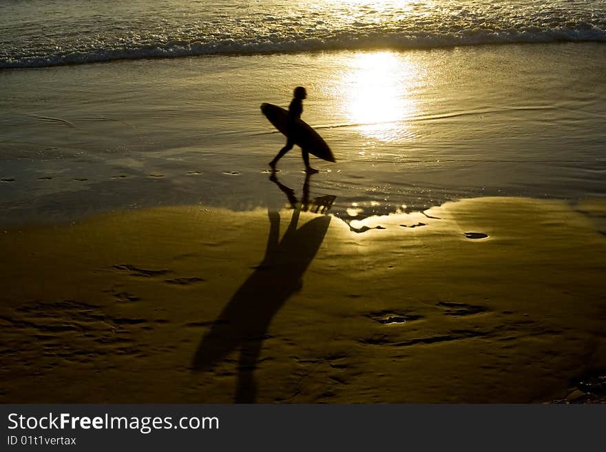 Silhouette of a male surfer at sunrise on the gold coast. Silhouette of a male surfer at sunrise on the gold coast