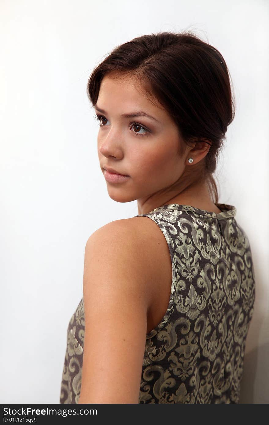 Portrait of young charming girl in dress on a white background