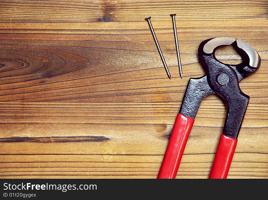 Nail and nail puller on a wood board