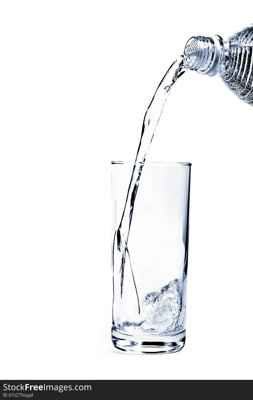 Mineral Water being poured into a glass from plastic bottle. Mineral Water being poured into a glass from plastic bottle