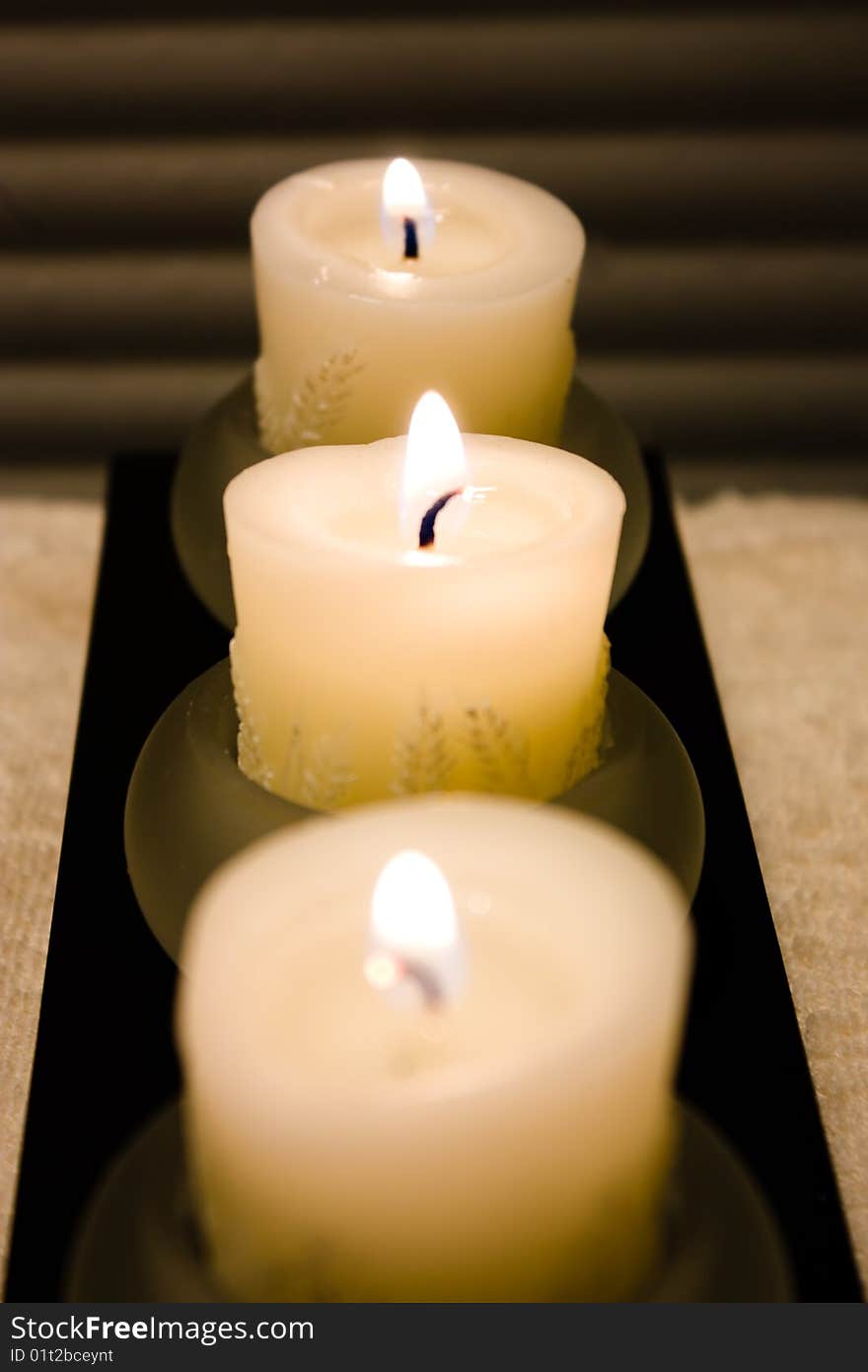 Three candles focus in the middle. Three candles focus in the middle