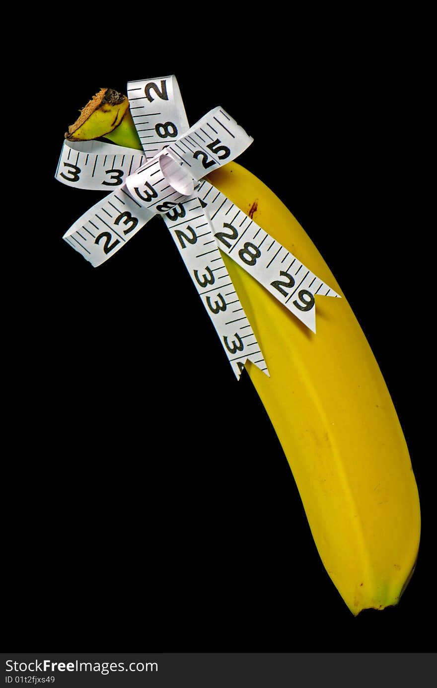 Measuring tape bow on banana. Measuring tape bow on banana.