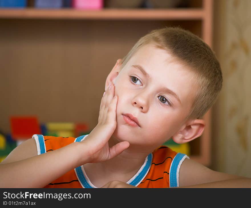 The boy of 7 years is engaged in a children's room