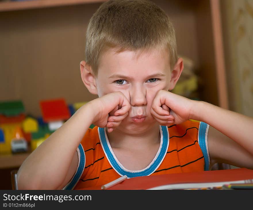 The boy of 7 years is engaged in a children's room