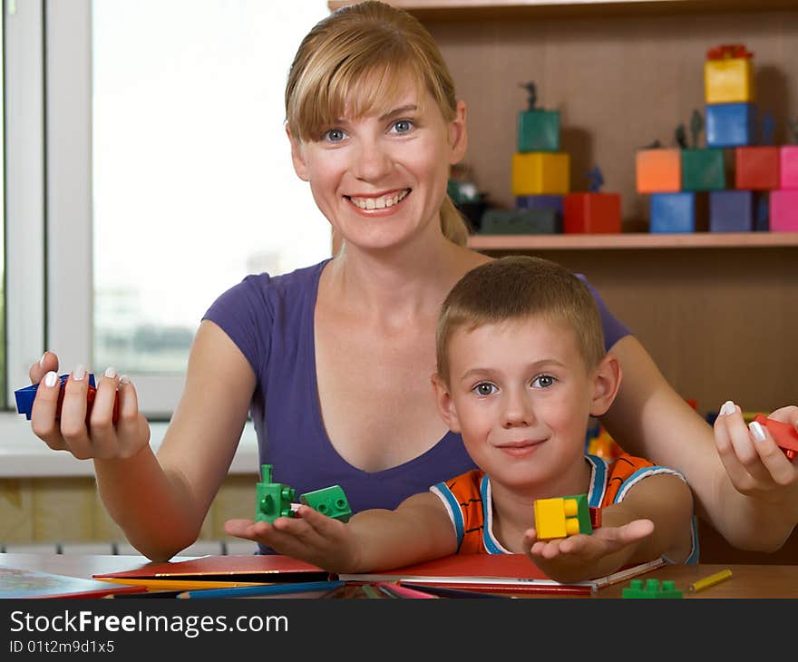 The mum with son is engaged in a children's room. The mum with son is engaged in a children's room