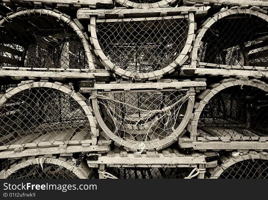 An image of old lobster traps resting by the sea.