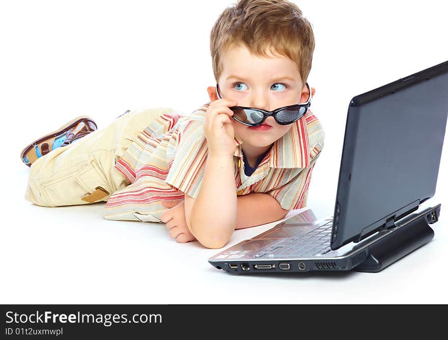 Concept of little businessman. Little child and laptop. Isolated on white background