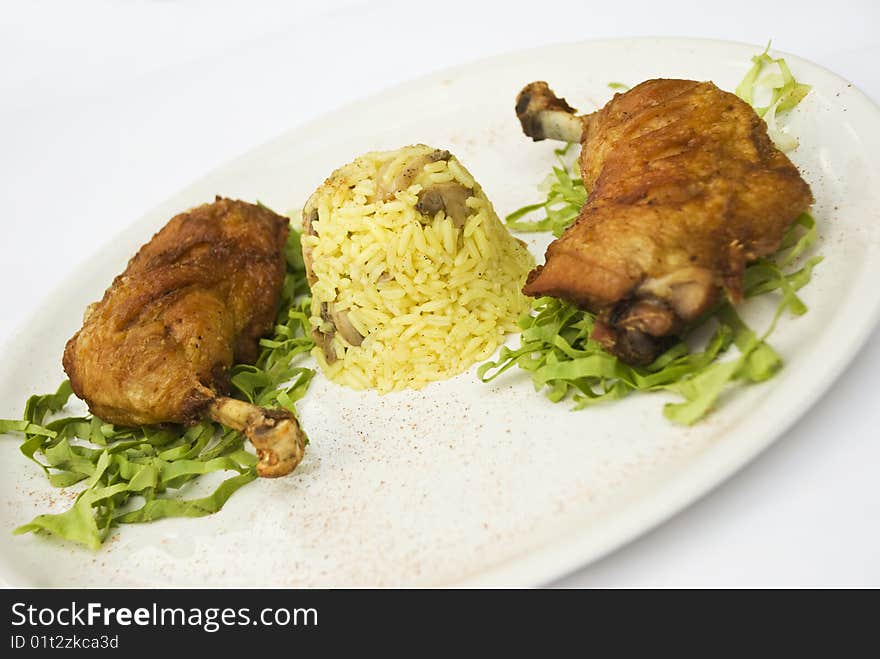 Chicken legs with rice garnish