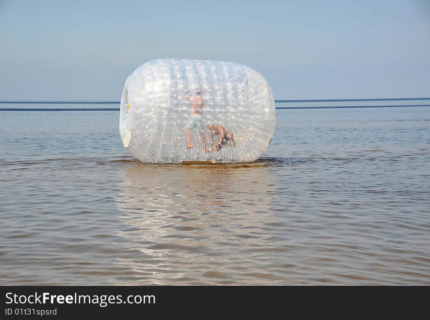 Attractsion the inflatable cylinder on a beach at coast in Jürmala (Latvia)