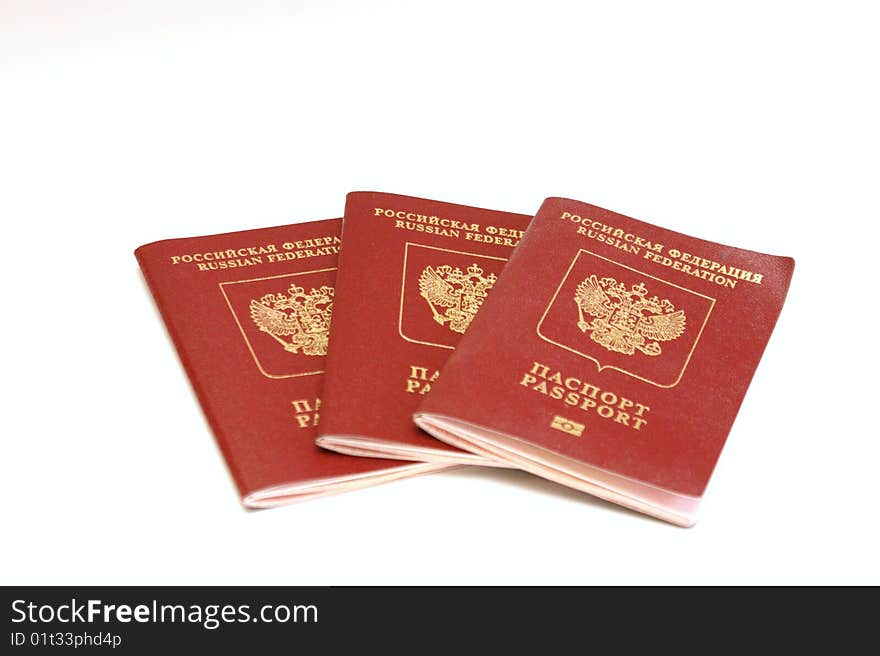 Three passports for travel abroad on a white background are removed by close up