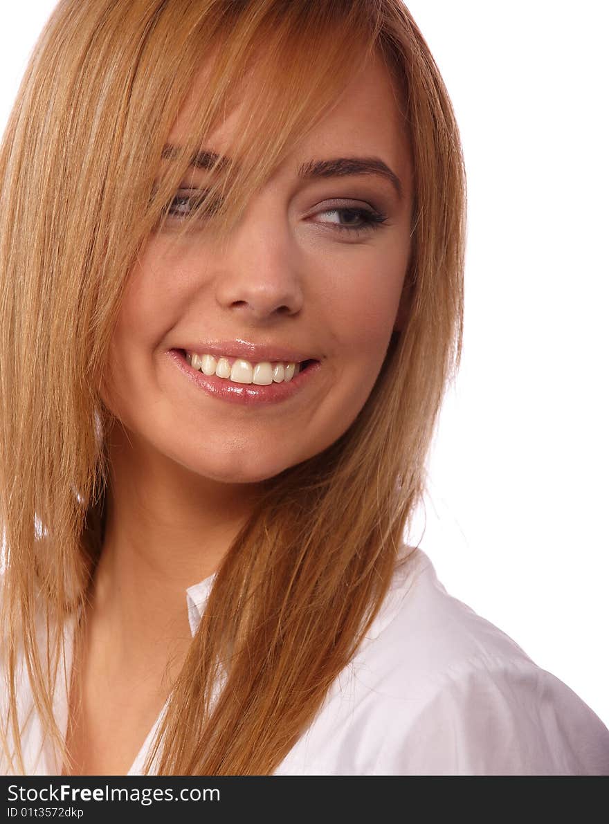 Portrait of a young beautiful smiling blonde in a white blouse on a light background. Portrait of a young beautiful smiling blonde in a white blouse on a light background