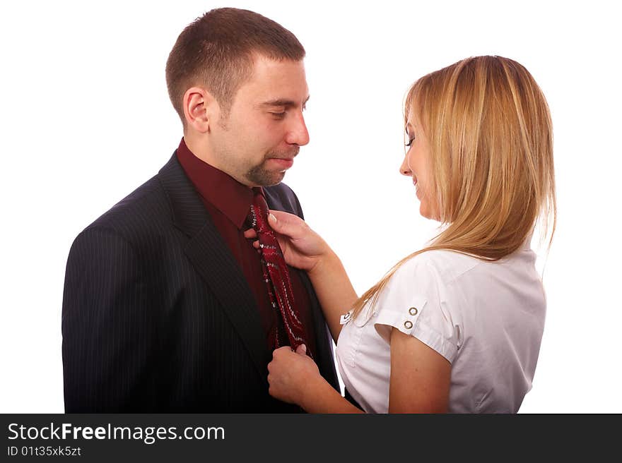 Beautiful blonde in a white blouse knotted necktie attractive man in a black suit. Beautiful blonde in a white blouse knotted necktie attractive man in a black suit