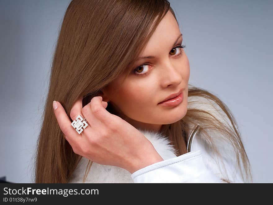 Portrait of a young beautiful brunettes, with a ring on the finger and a leather jacket with white fur. Portrait of a young beautiful brunettes, with a ring on the finger and a leather jacket with white fur