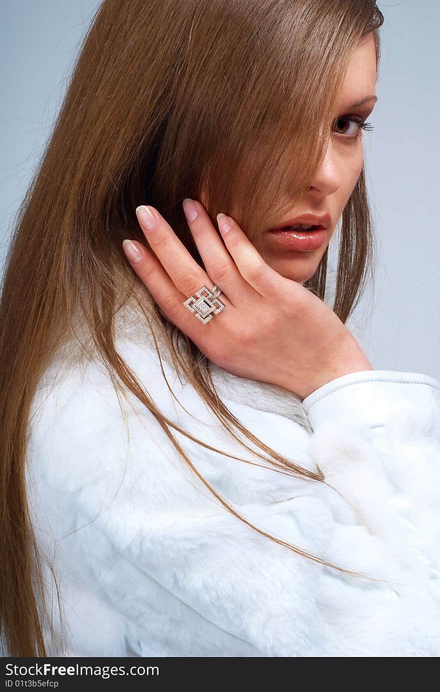 Portrait of a young beautiful brunettes, with a ring on the finger and a leather jacket with white fur. Portrait of a young beautiful brunettes, with a ring on the finger and a leather jacket with white fur