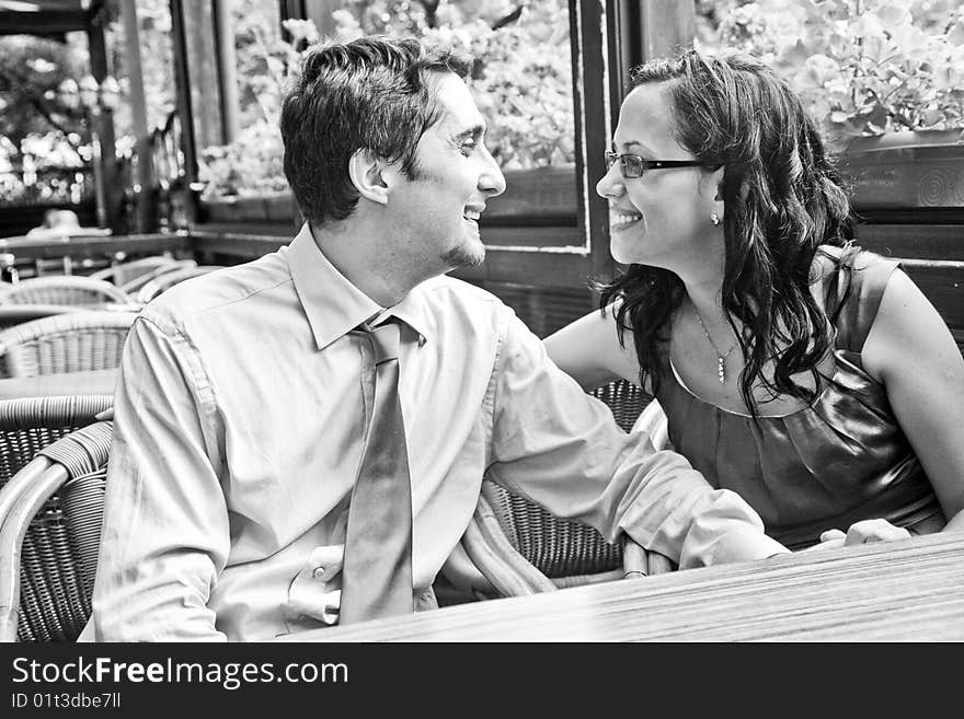 Happy carefree couple laughing at restaurant table. Happy carefree couple laughing at restaurant table