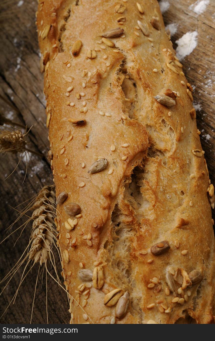 Close up with delicous bread, grain isolated on wood