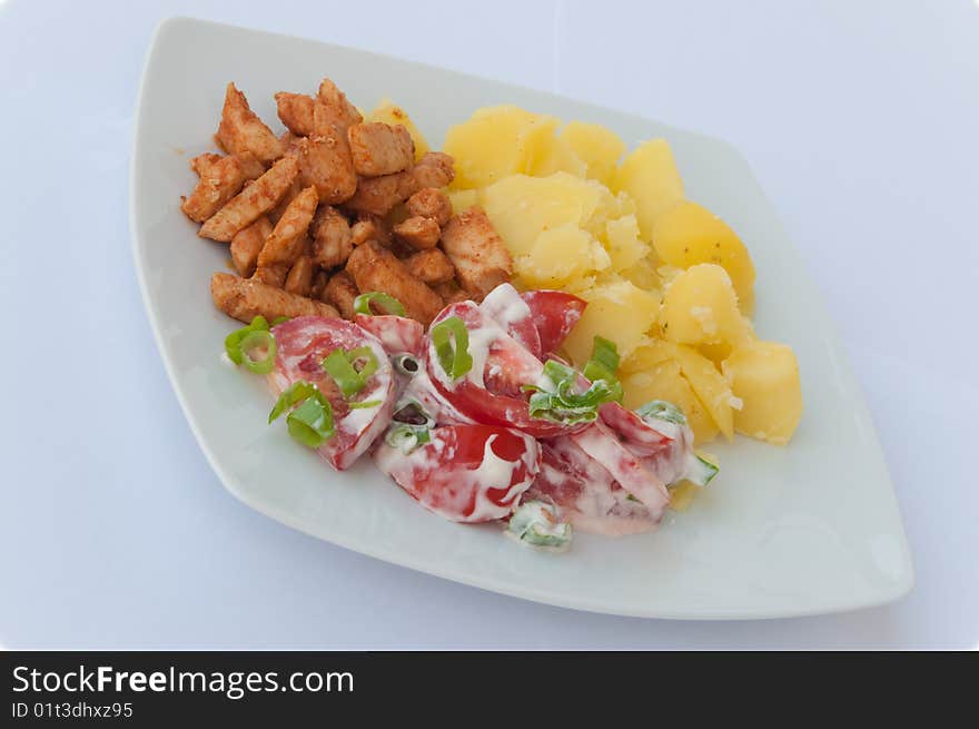 Meat, tomatoe with mayonnaise, onion and potato on a basin. Meat, tomatoe with mayonnaise, onion and potato on a basin