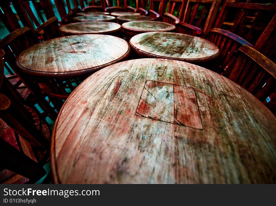 A cluster of round tables awaiting business to be resumed.