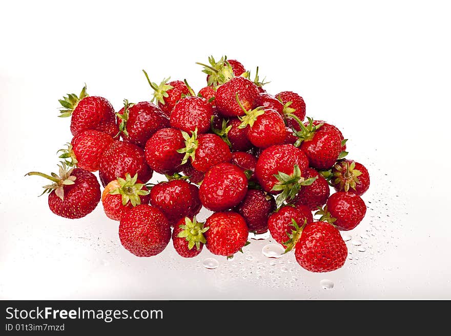 Fresh, red strawberries with waterdrops on a natural white background