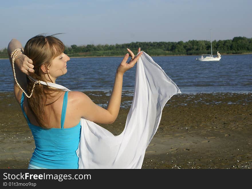 Romantic girl on a bank of the river