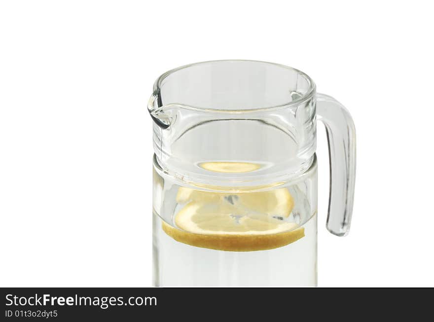 Glass jug with water and lemon