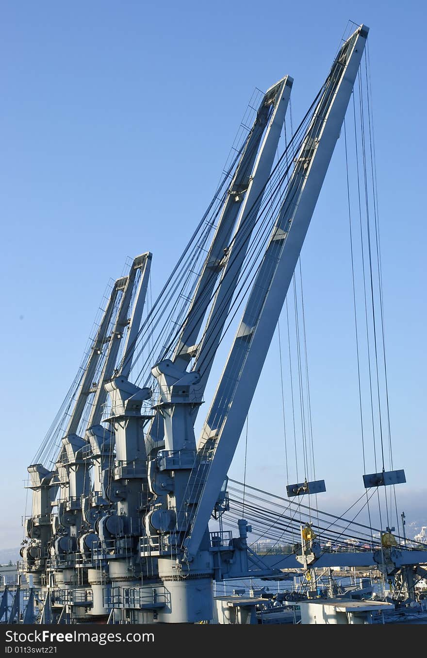 Cranes in dockyard - perspective against blue sky