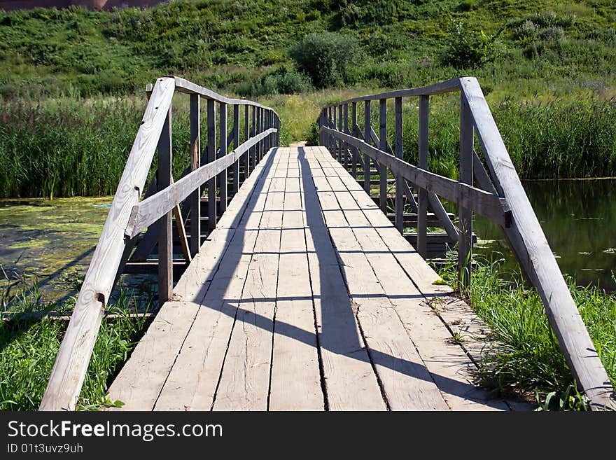 The bridge through the river on a background of a fortress