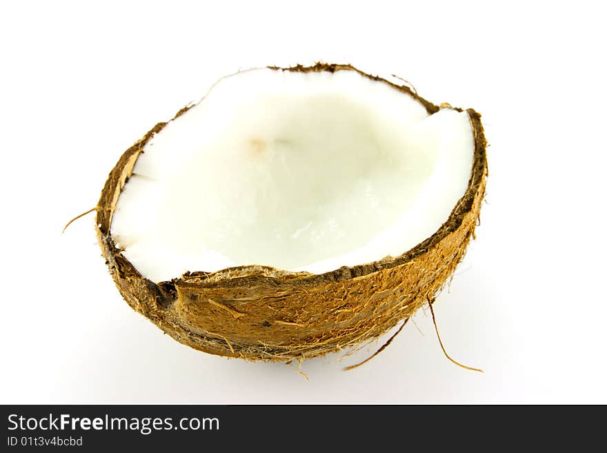 Half a brown hairy coconut on a white background. Half a brown hairy coconut on a white background