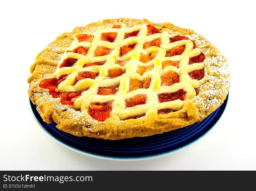 Whole apple and strawberry pie on a blue plate on a white background