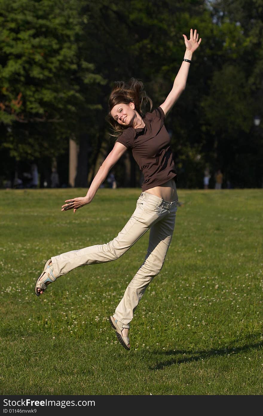 Young girl jumping in the park. Young girl jumping in the park