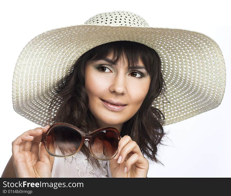 Romantic portrait of young woman in white hat with big sunglasses