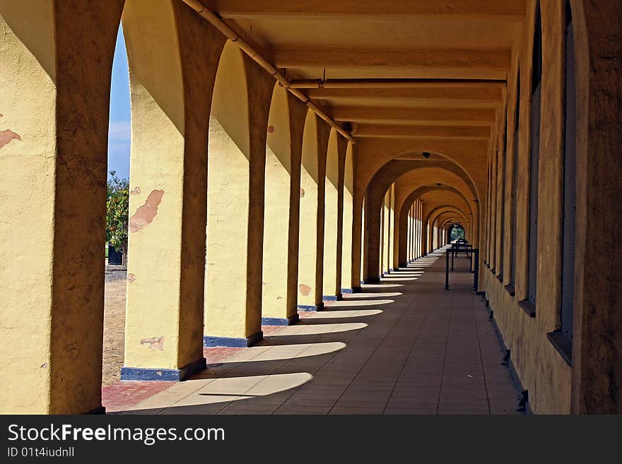 Historic (1923) arched walkway is part of the navy barracks at the old Naval Training Center in San Diego, now part of Liberty Station. The Spanish Colonial Revival style with open-air porches and arches is being preserved. Historic (1923) arched walkway is part of the navy barracks at the old Naval Training Center in San Diego, now part of Liberty Station. The Spanish Colonial Revival style with open-air porches and arches is being preserved.