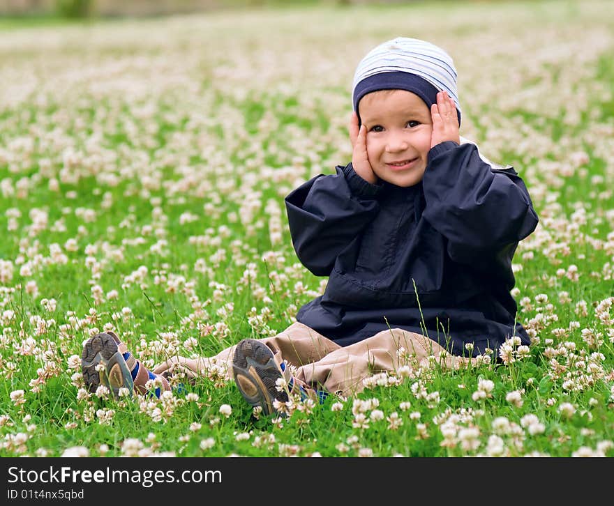 Surprised Caucasian Boy In a Field Full Of Clover Flowers. Surprised Caucasian Boy In a Field Full Of Clover Flowers