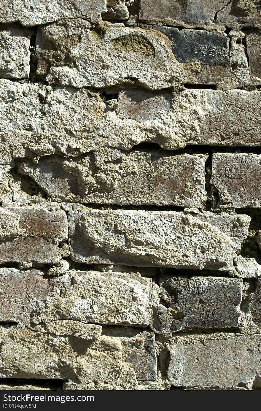 Image taken of an old brick wall that has started to crack and fall apart.