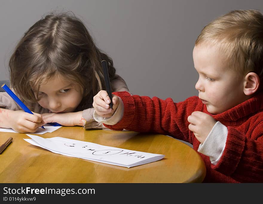 Little boy and girl drawing a picture together